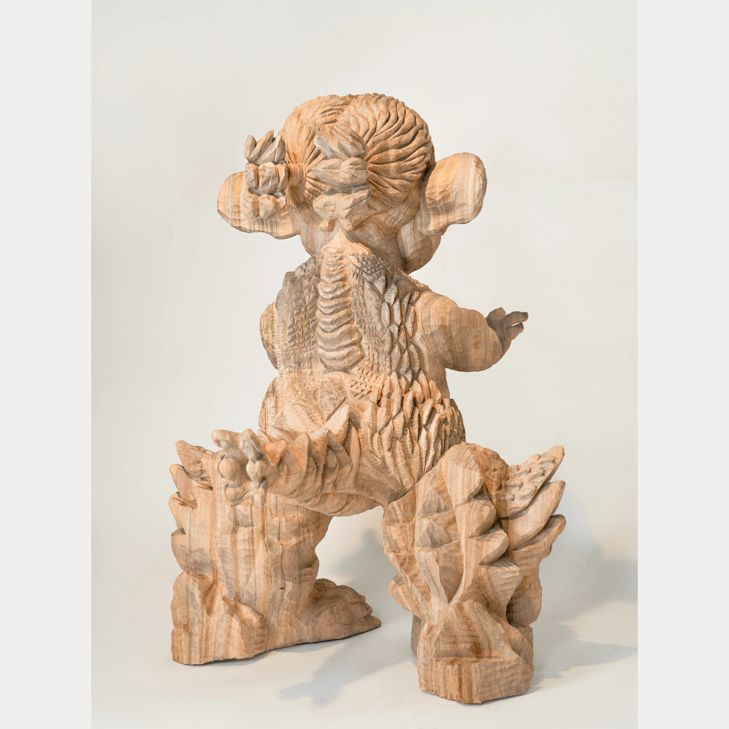 MINIRA, rear view showing carved scales along the back and legs